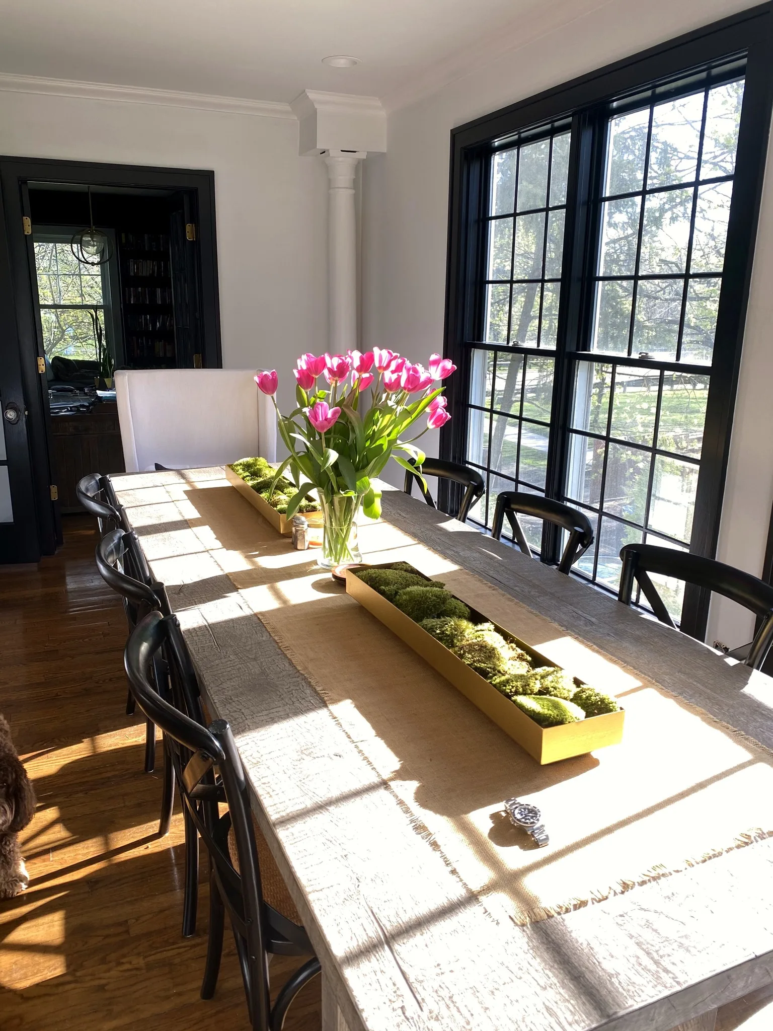 Bright dining room with tulips and original stained-glass windows