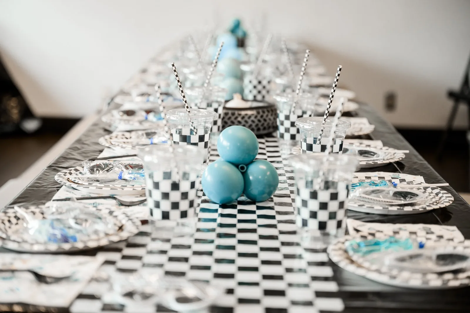 Vintage race car party backdrop with powder-blue balloons